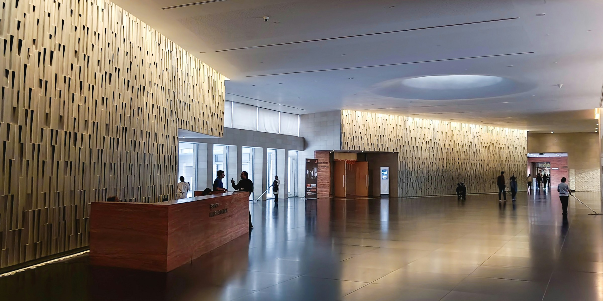 Modern corporate lobby with people, signaling institutional partnership scale