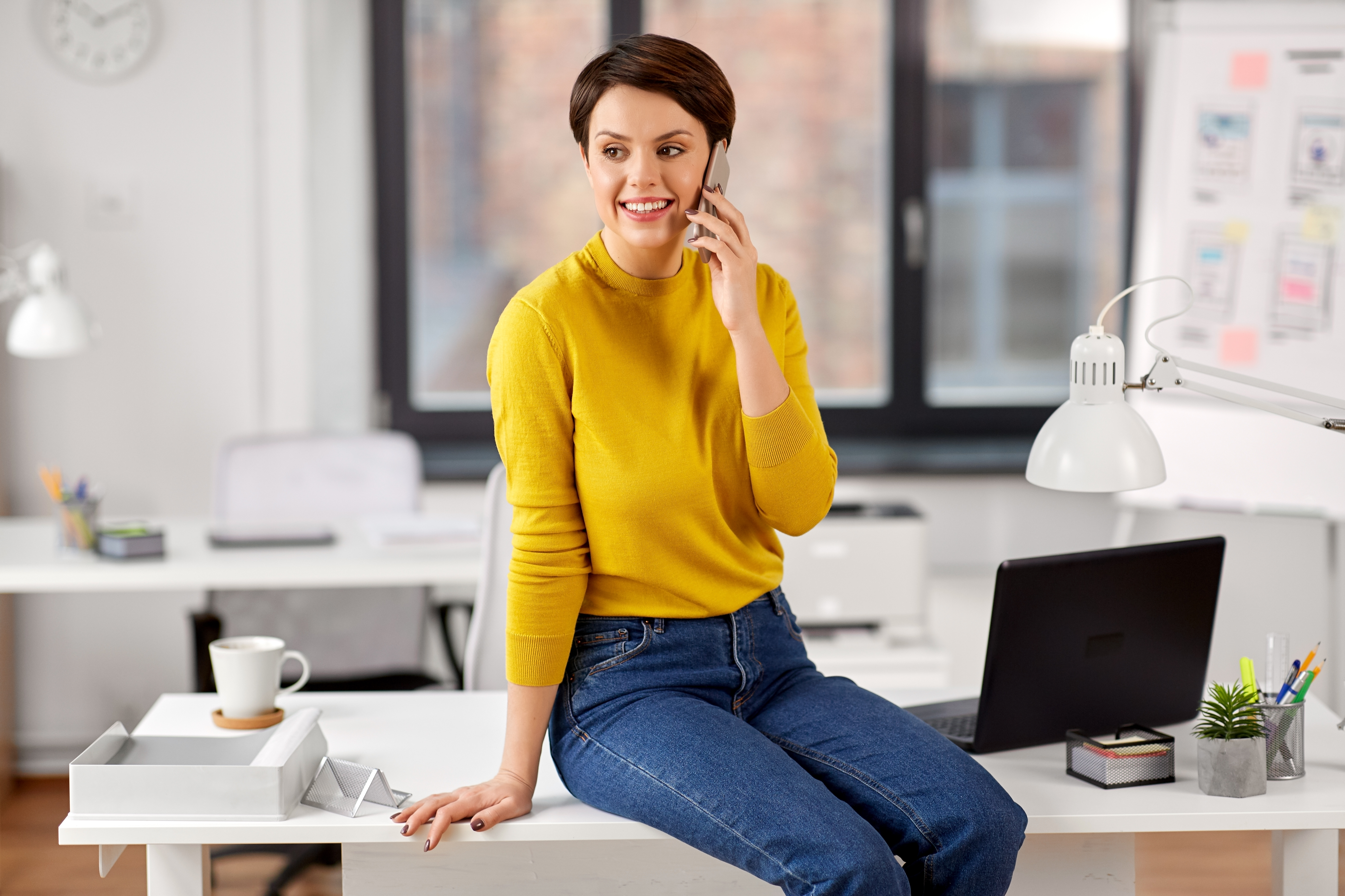 OnDemand strategist on a call in a bright office, smiling mid-conversation